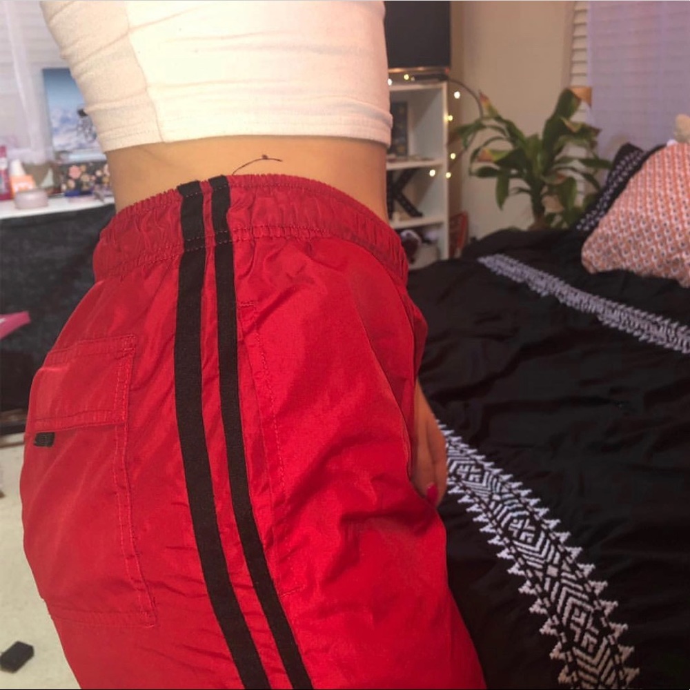 red sweat pants with black stripes
